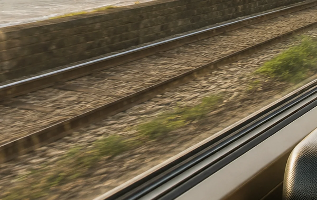 Railway tracks seen from a train window for budget UK trips